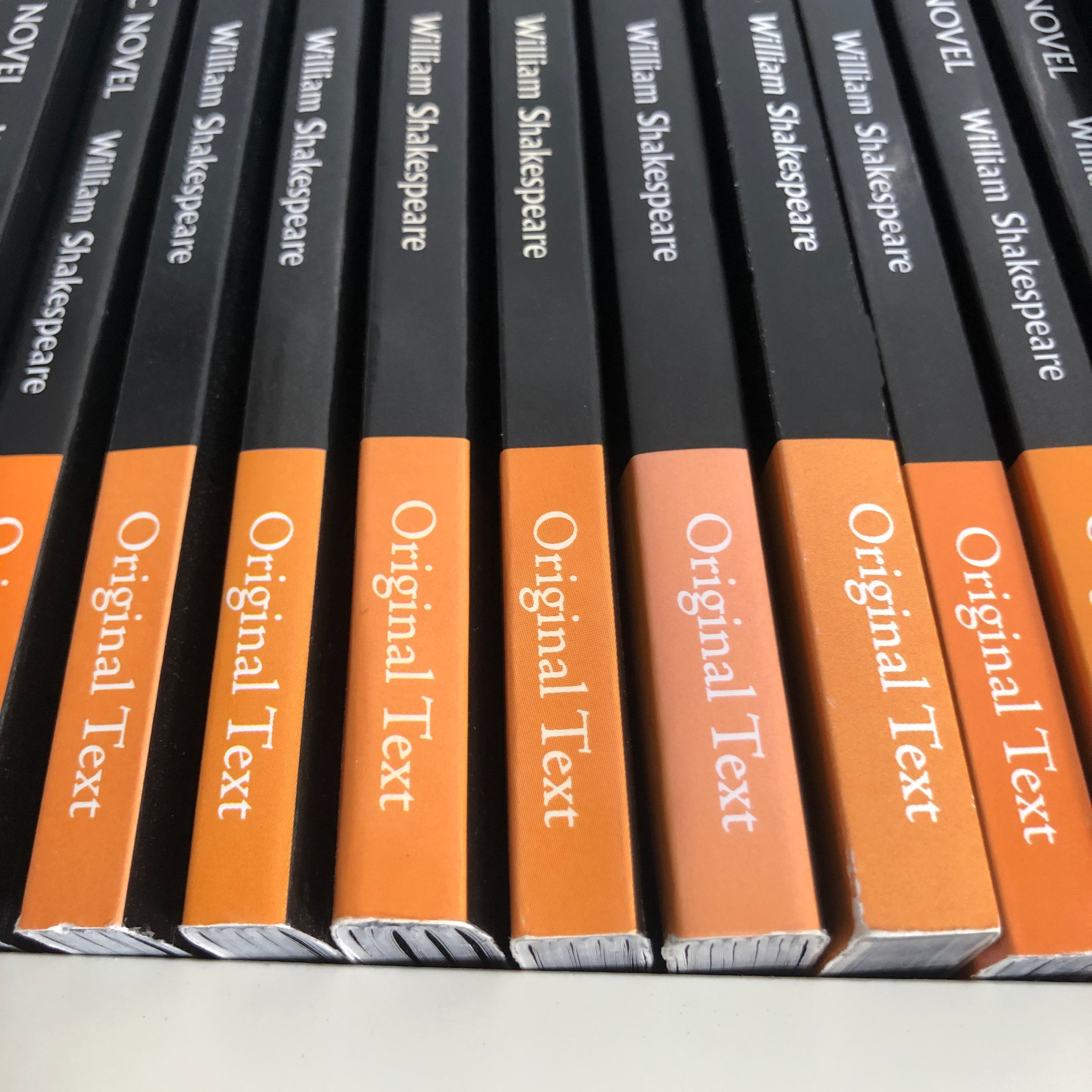 A bookshelf of Classical Comics Original Text graphic novels showing their orange spines.