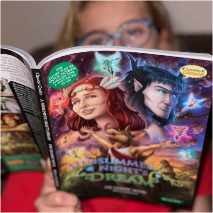 A teenager holding and reading the Quick Text graphic novel of A Midsummer Night's Dream